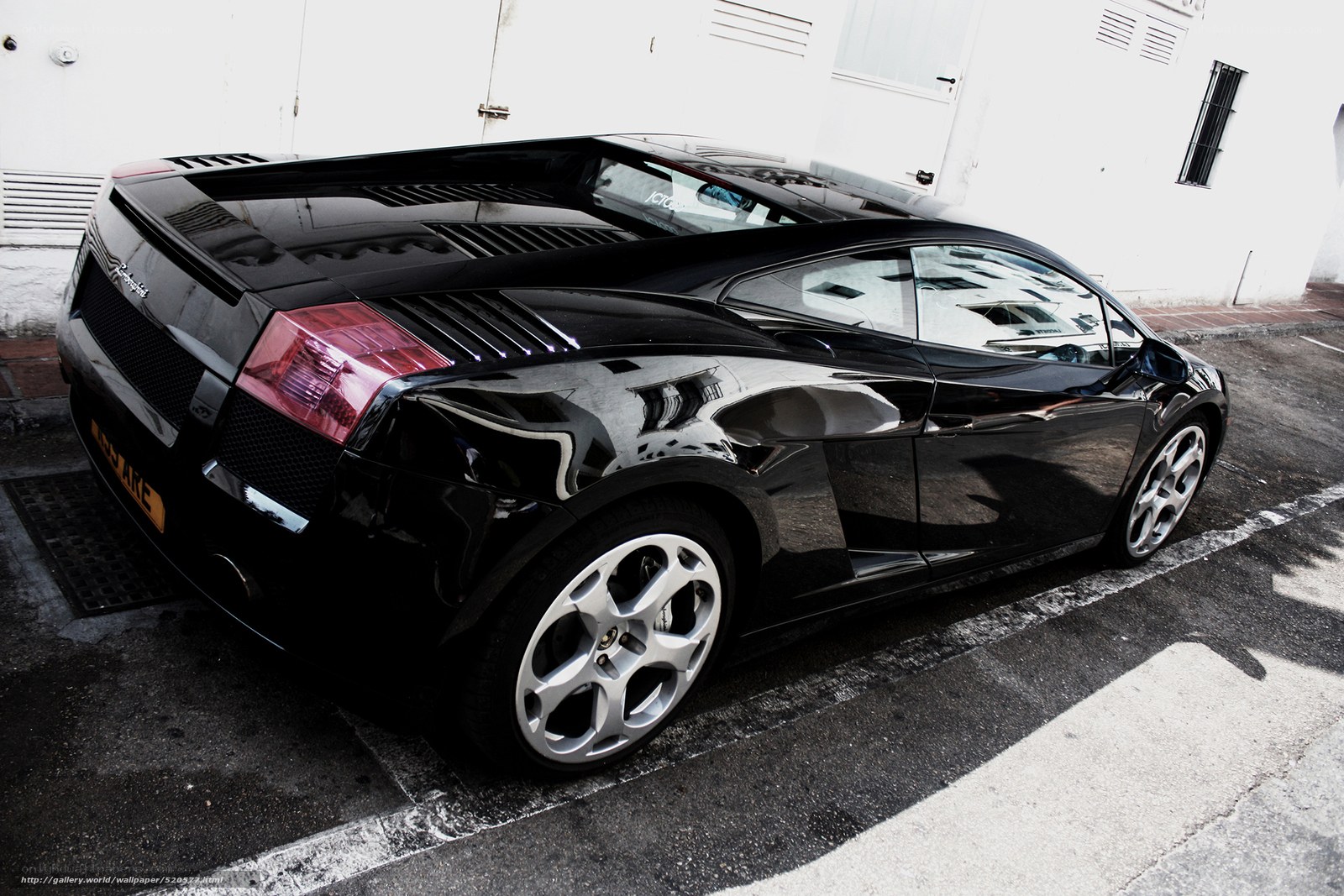 Black Lamborghini parked in lot