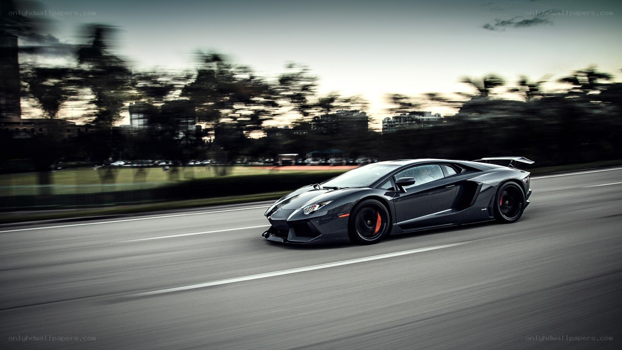 Black Lamborghini speeding on road