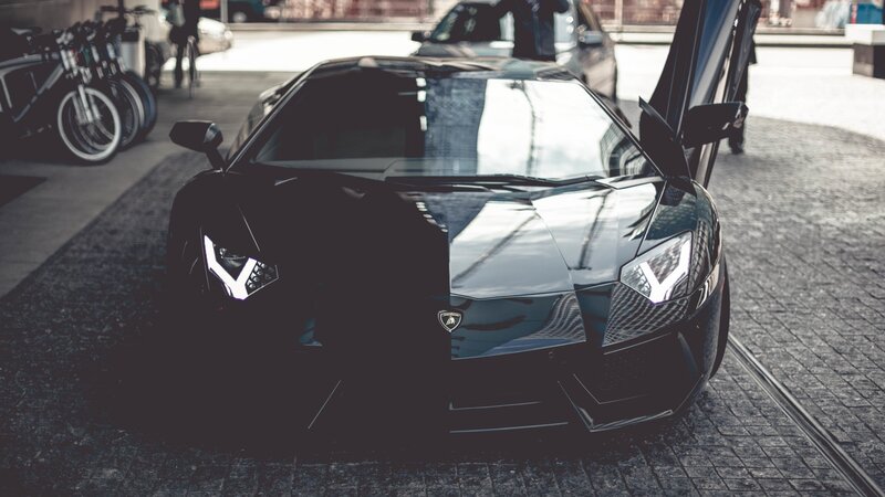Black Lamborghini Sports Car — Dramatic, Afternoon, Photograph, Bicycles