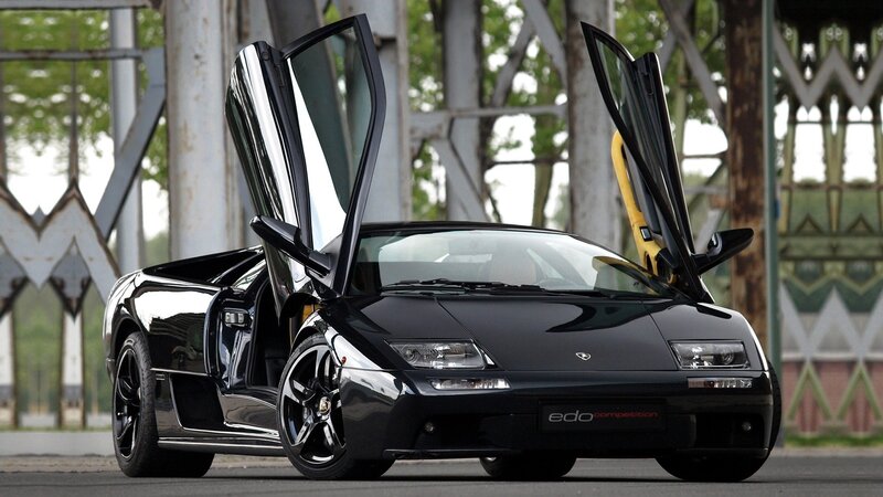 Black Lamborghini Sports Car — Dramatic, Afternoon, Photograph, Car Doors, Bridge Structure