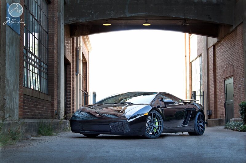 Black Lamborghini under a bridge