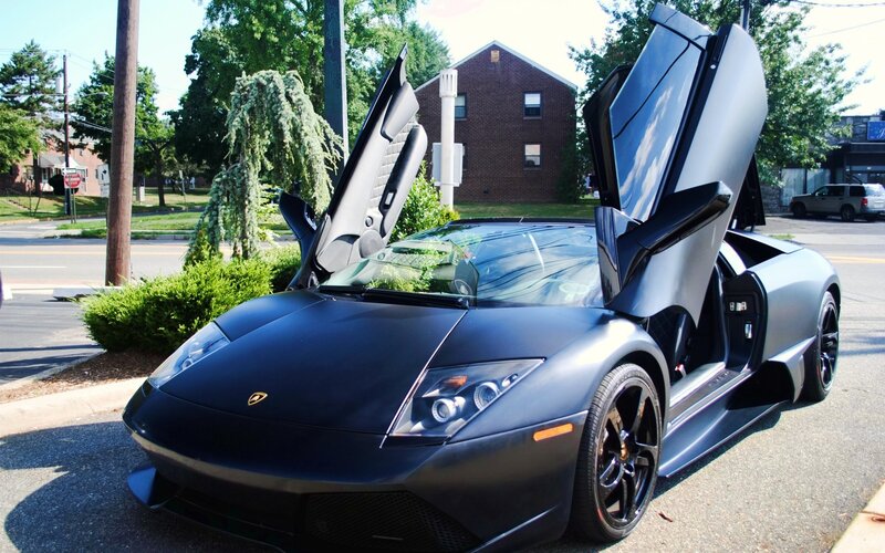 Black Lamborghini with doors open