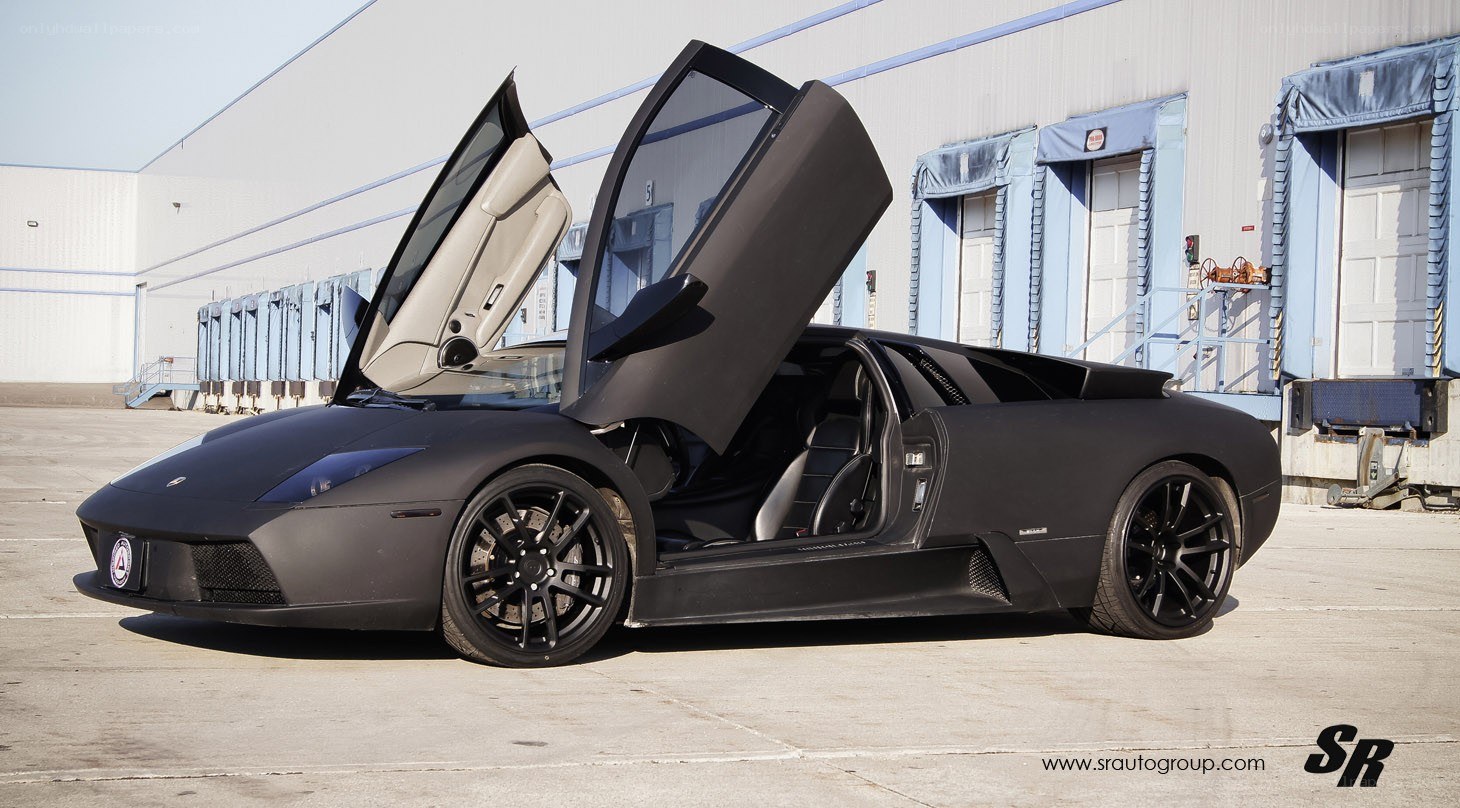 black lamborghini with doors open