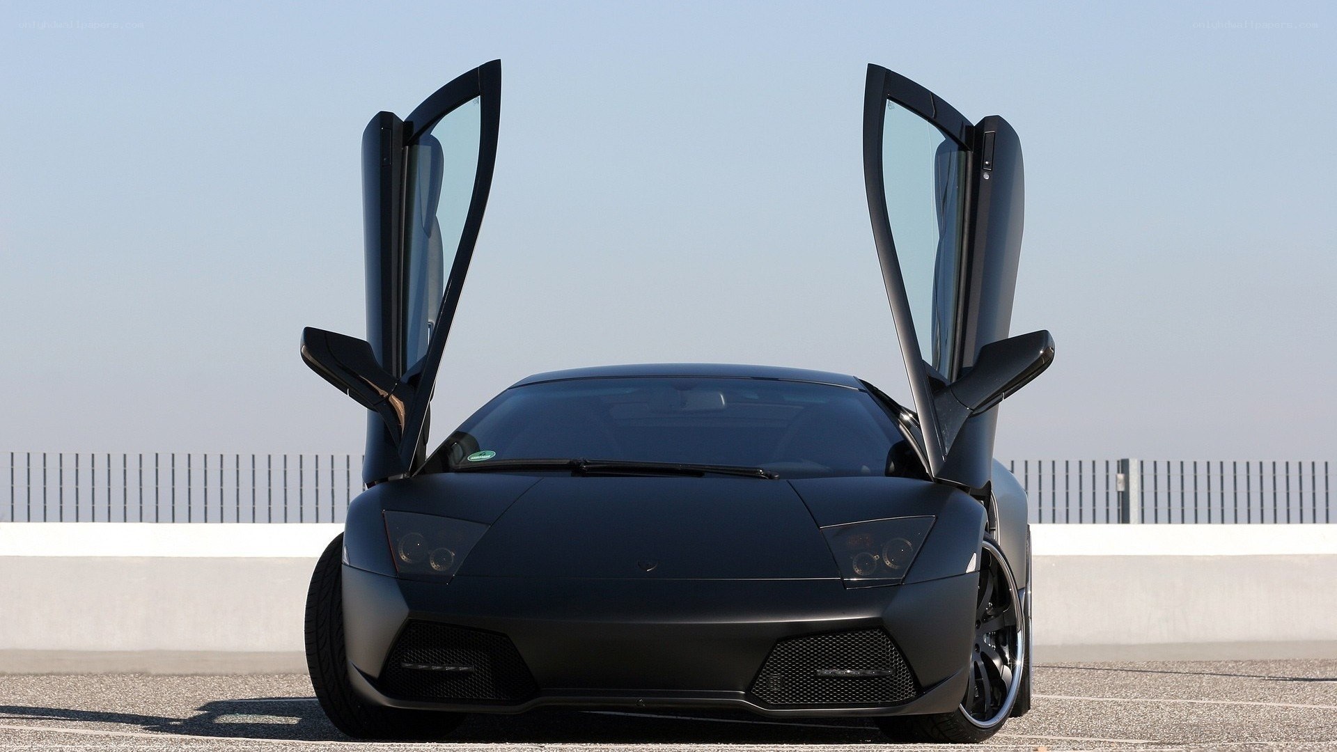 black lamborghini with doors open