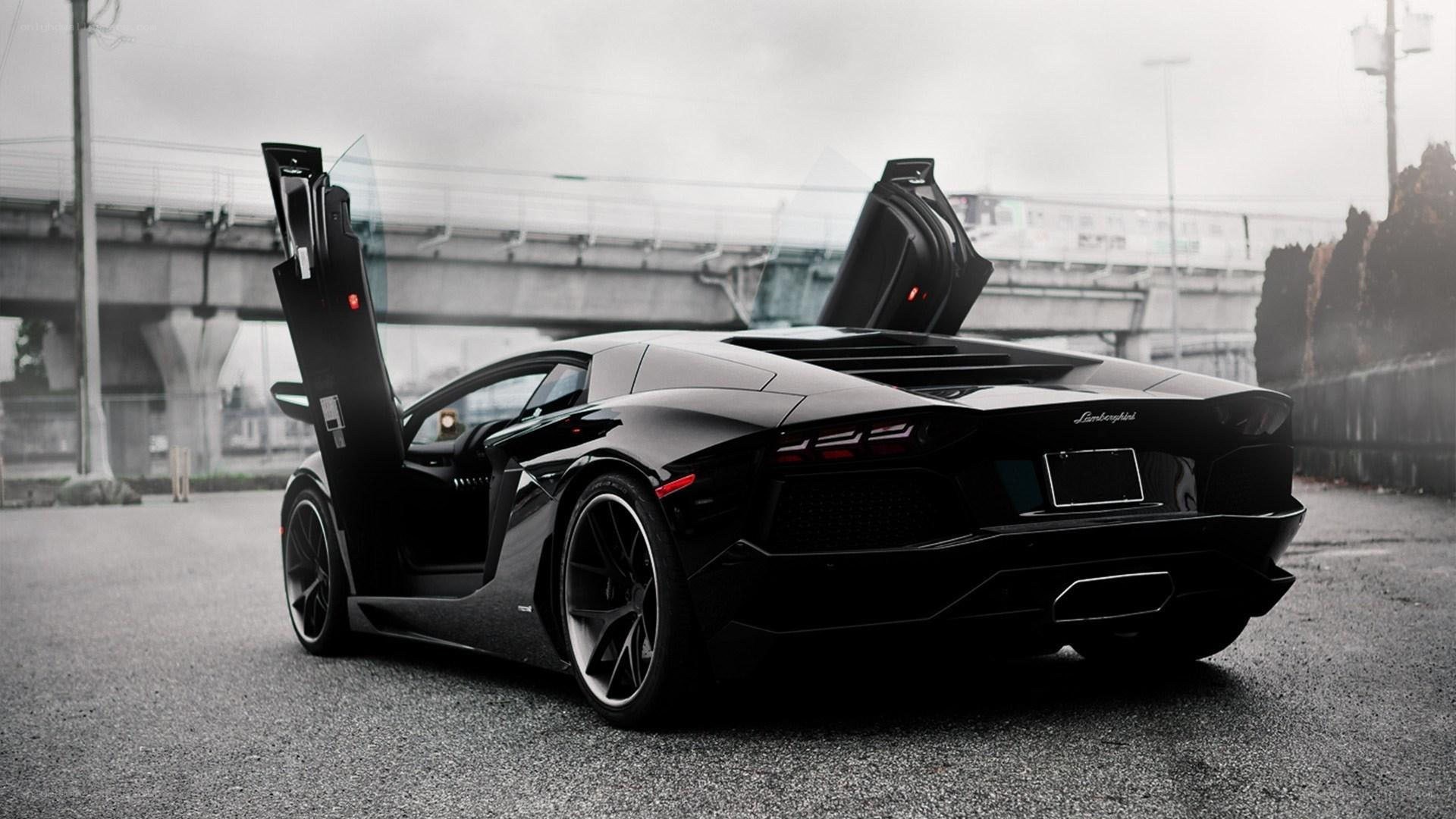 black lamborghini with doors open