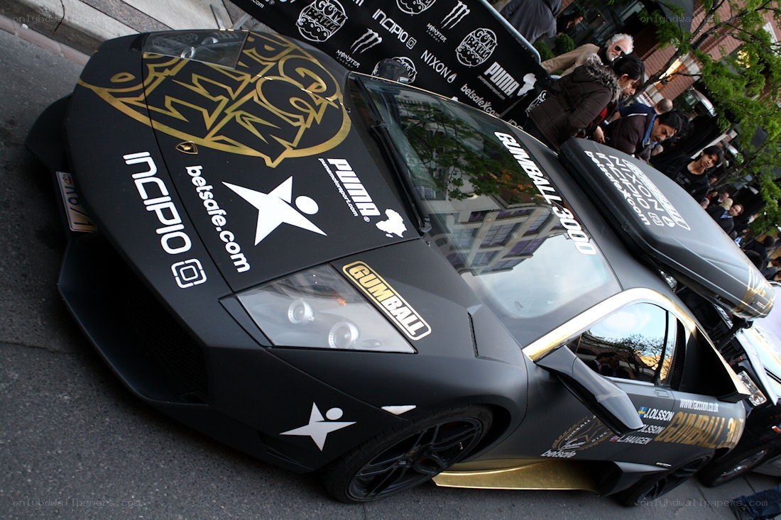black lamborghini with sponsor logos