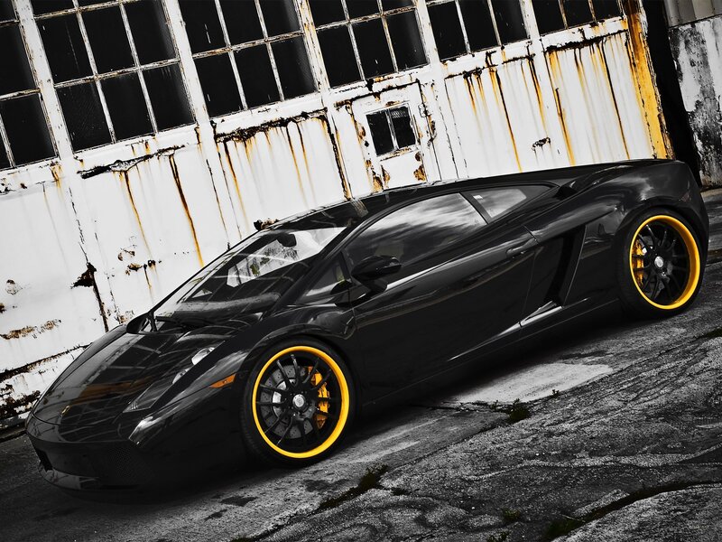 Black Lamborghini with yellow rims