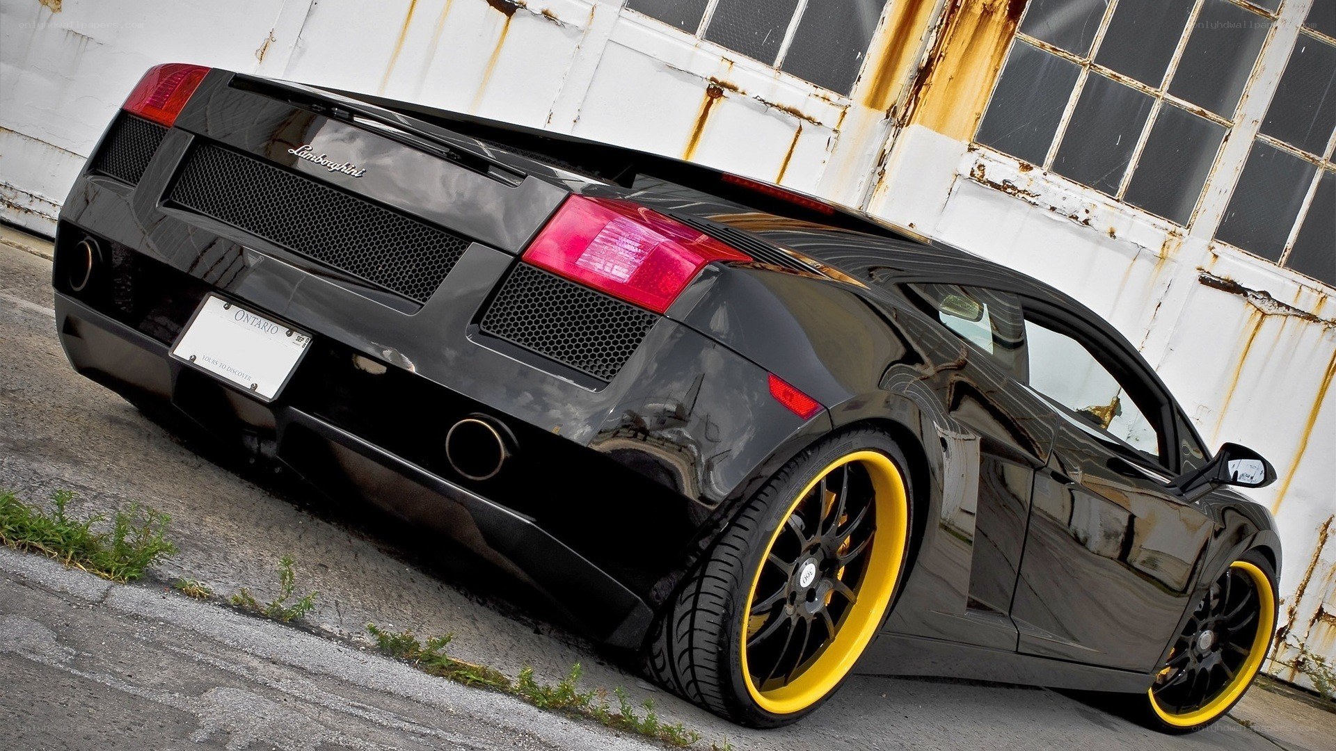 Black Lamborghini with yellow wheels