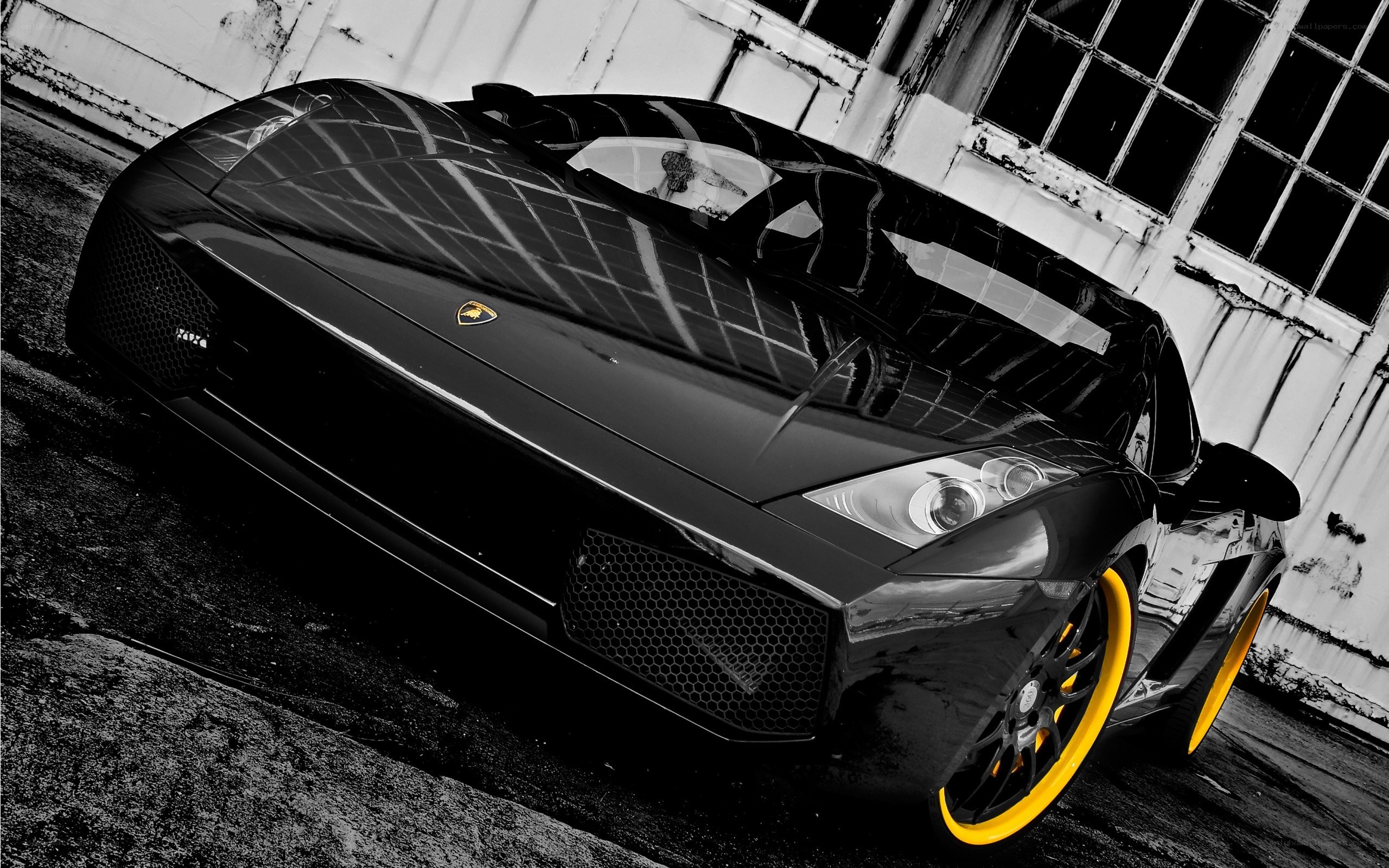 Black Lamborghini with yellow wheels