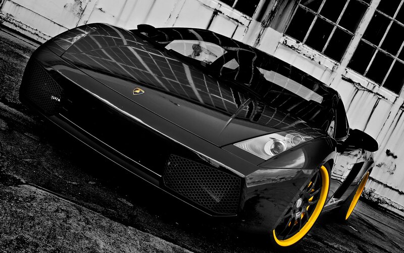 black lamborghini with yellow wheels