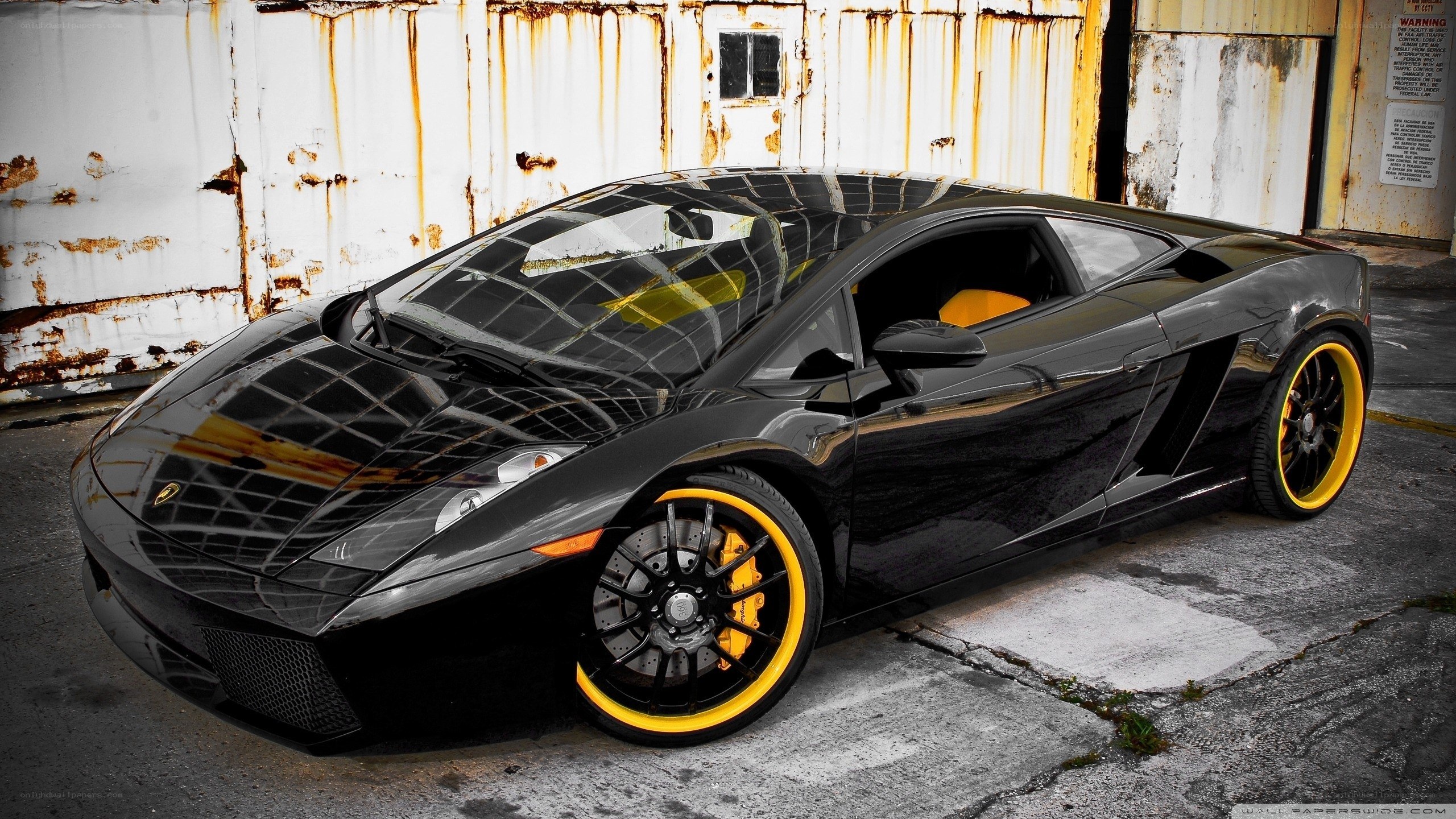 black lamborghini with yellow wheels