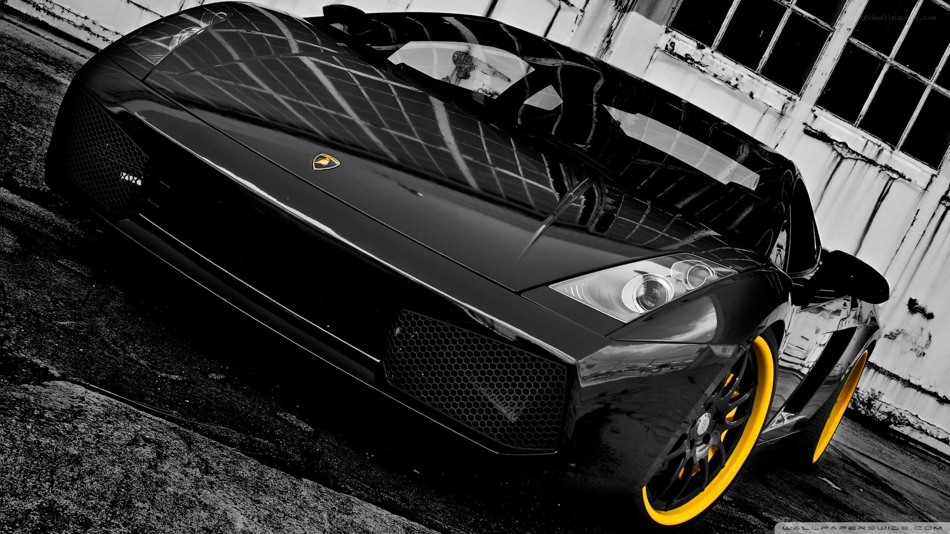 Black Lamborghini with yellow wheels