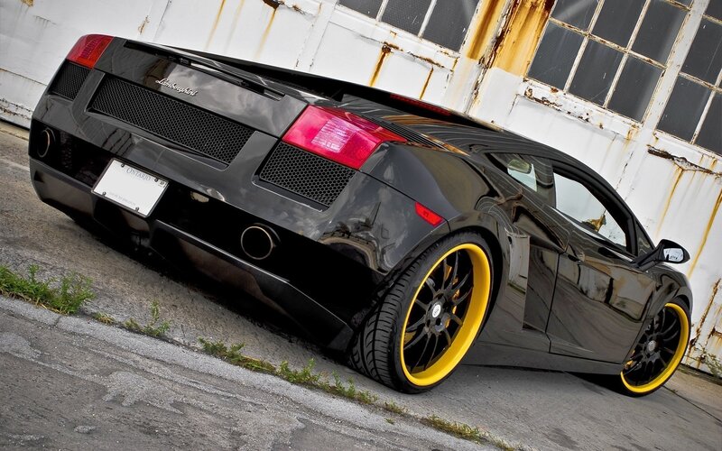 Black Lamborghini with yellow wheels