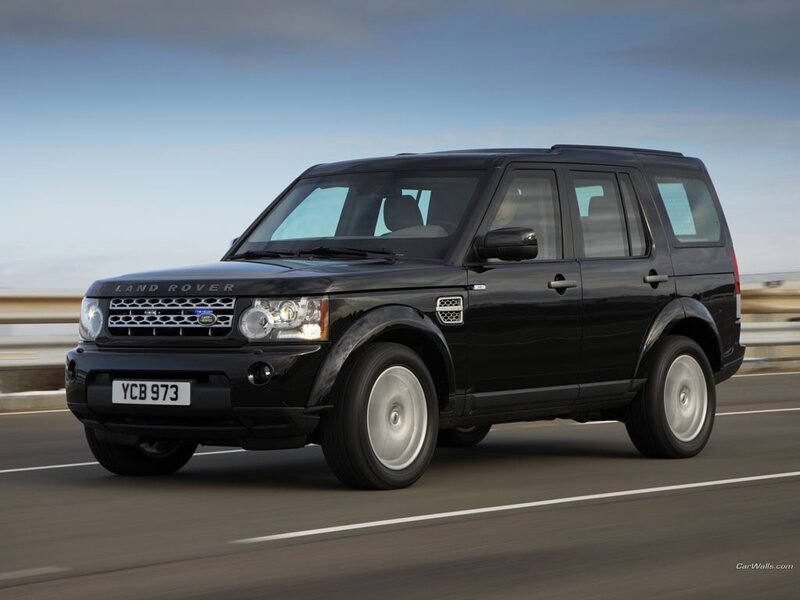 Black Land Rover driving on road
