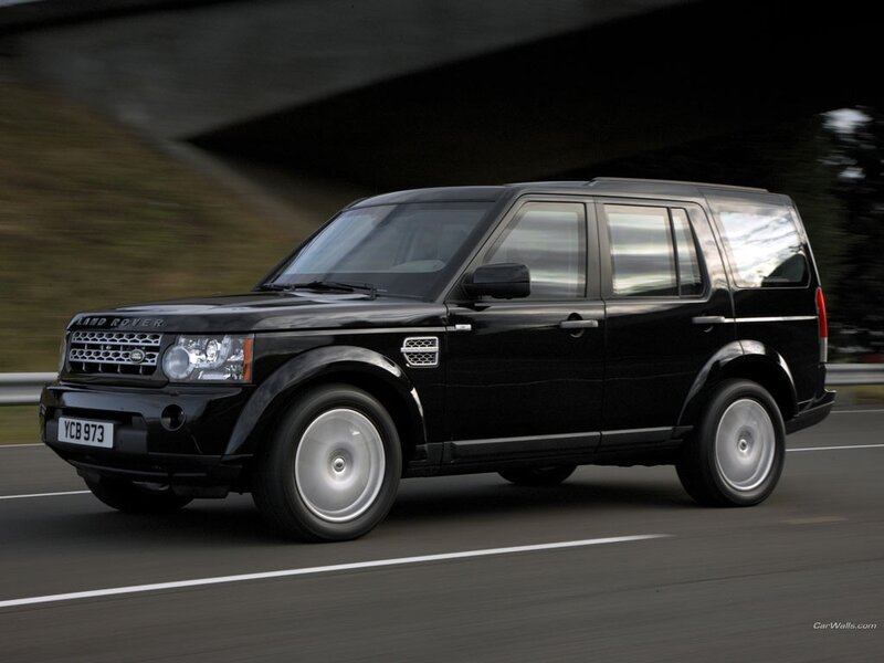 Black Land Rover driving on road