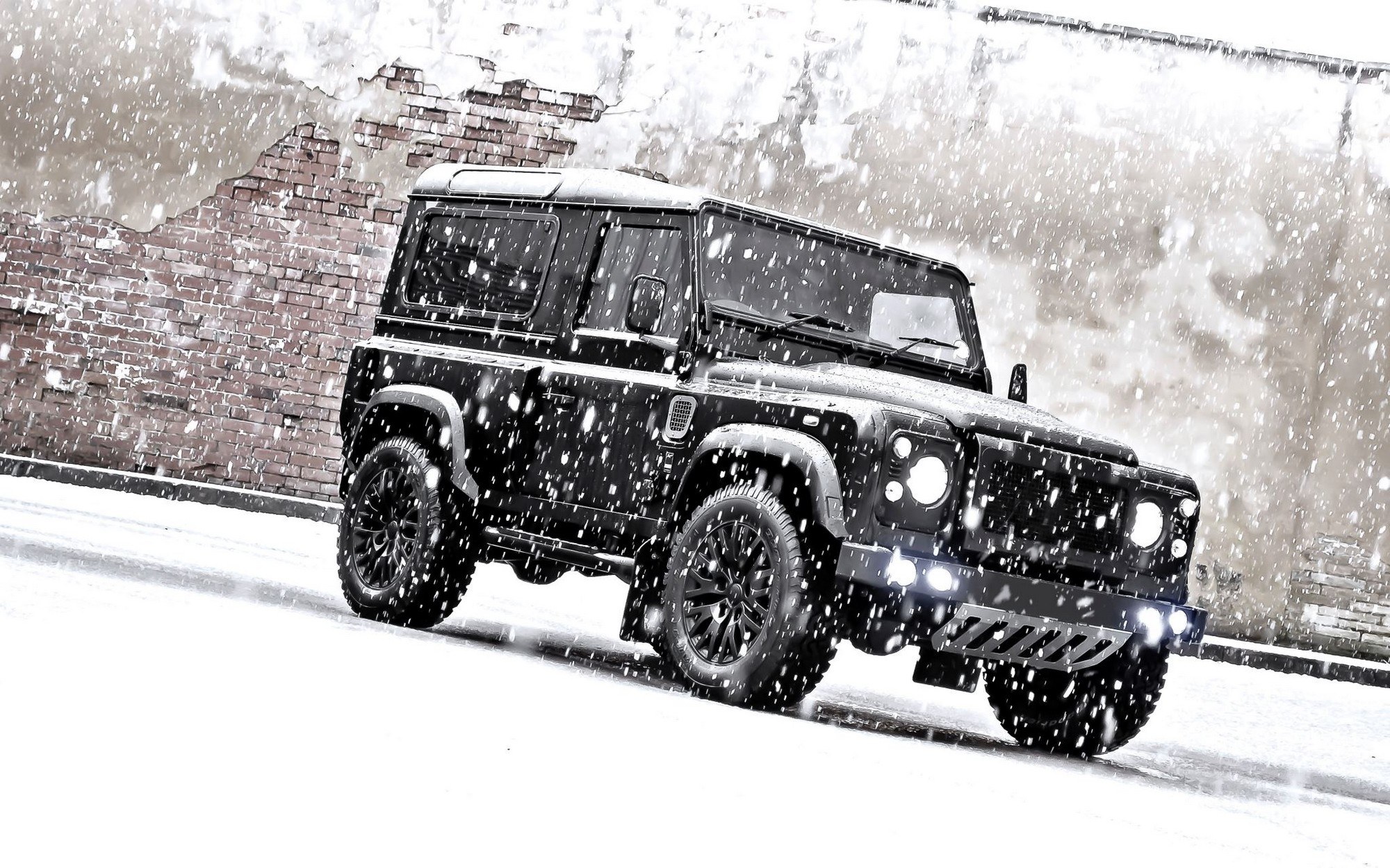 Black Land Rover in snow