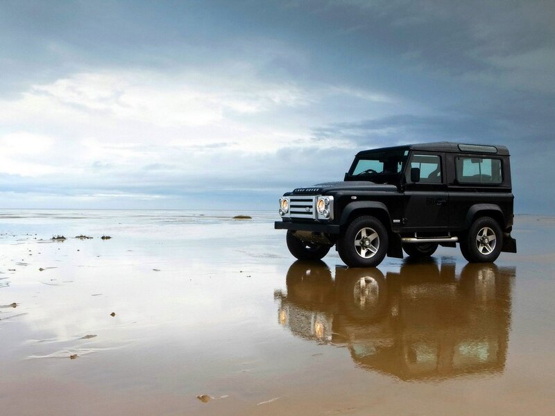 Black Land Rover on beach