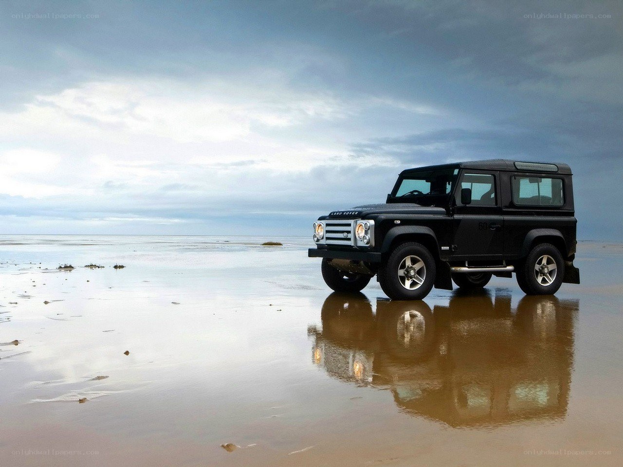 Black Land Rover on beach