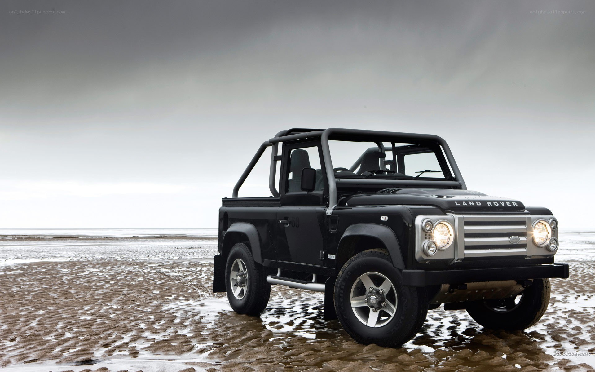 Black Land Rover on beach
