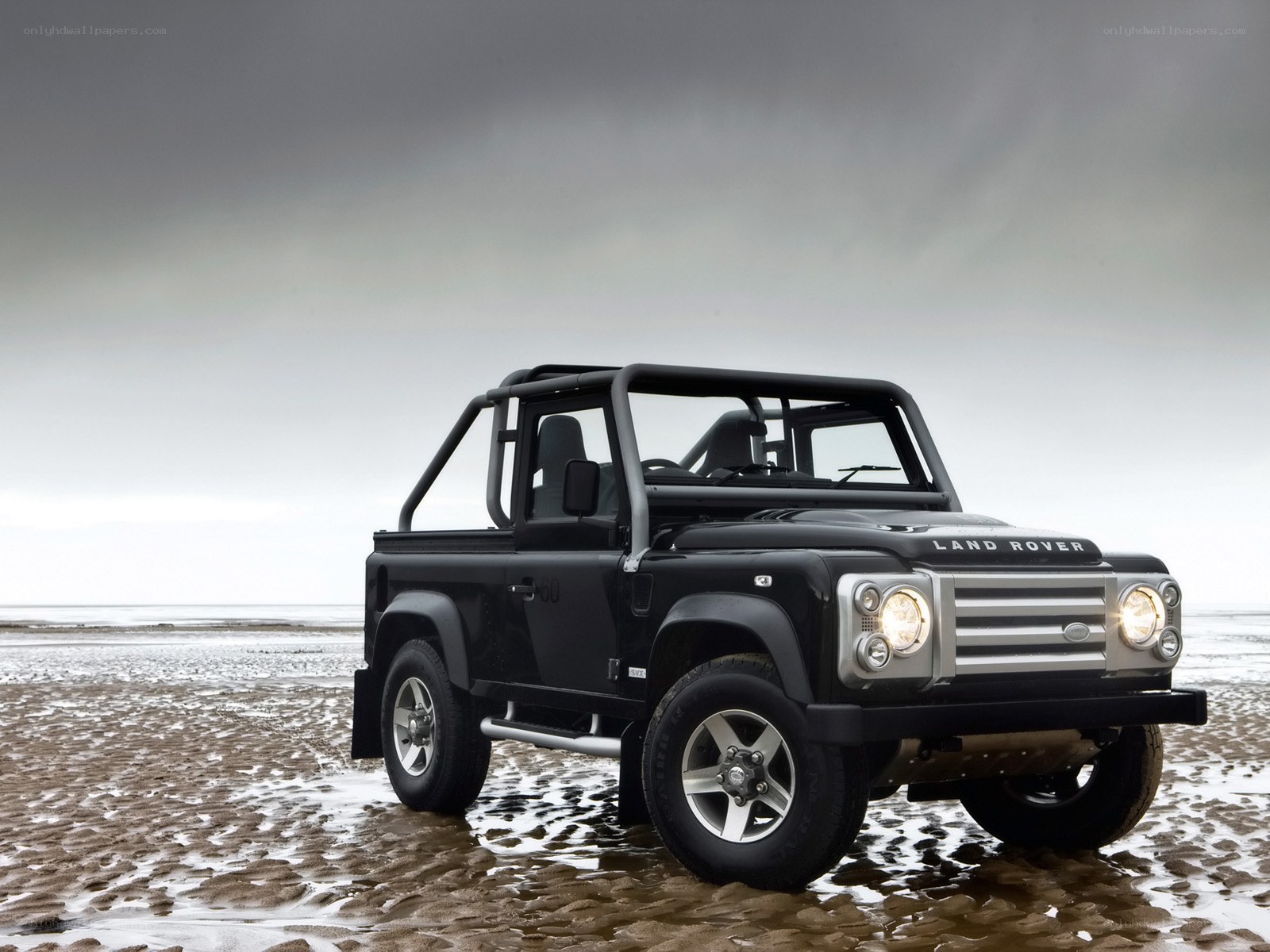 Black Land Rover on beach