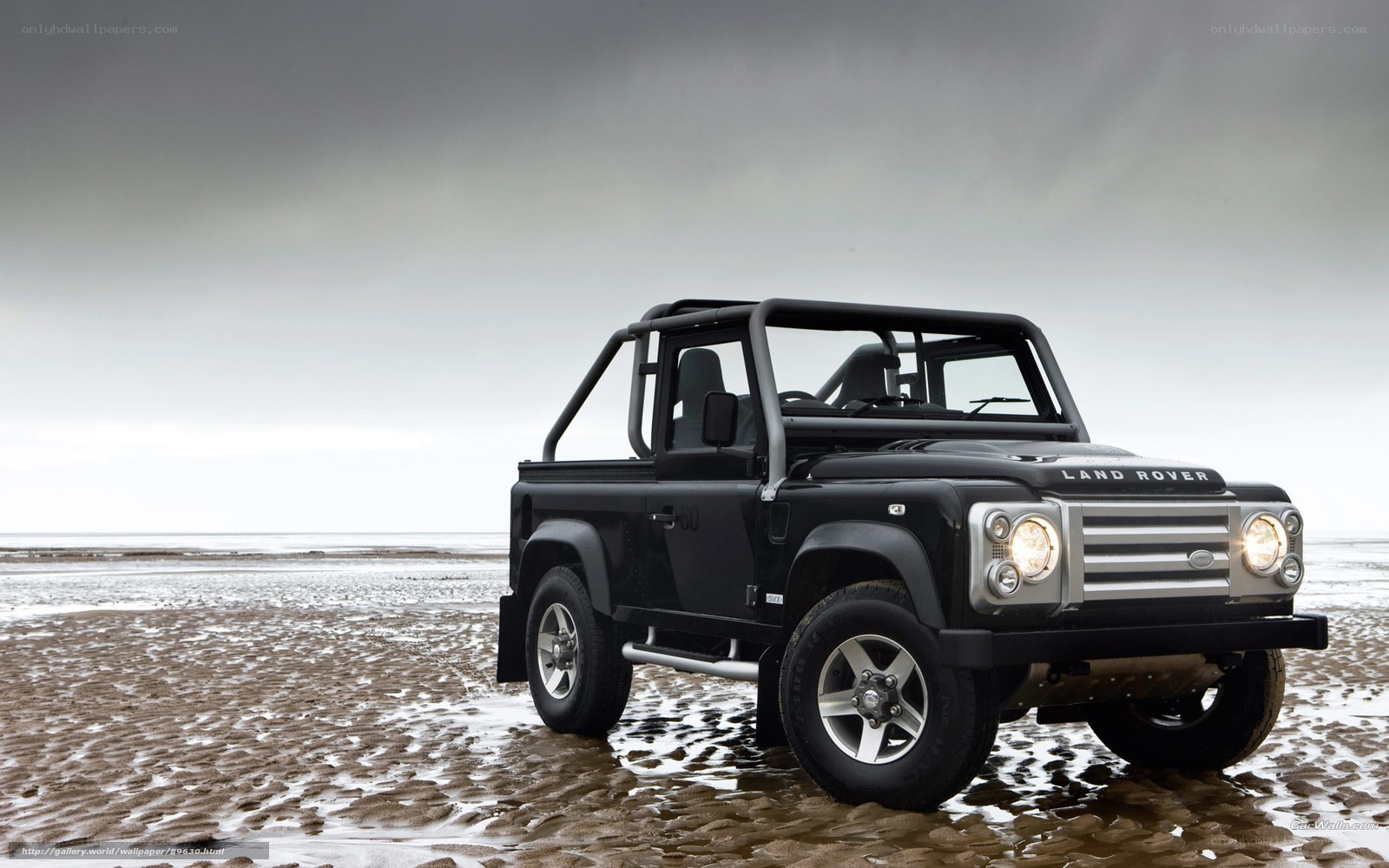 Black Land Rover on beach