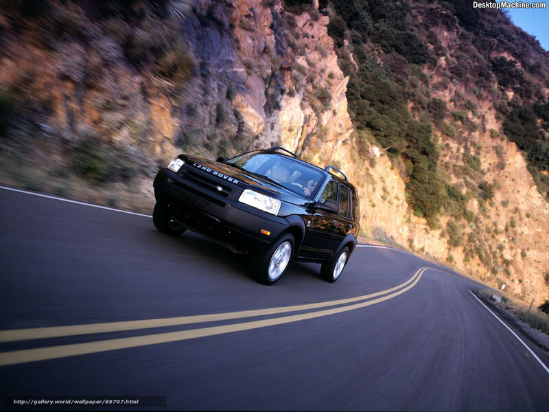 Black Land Rover on winding road