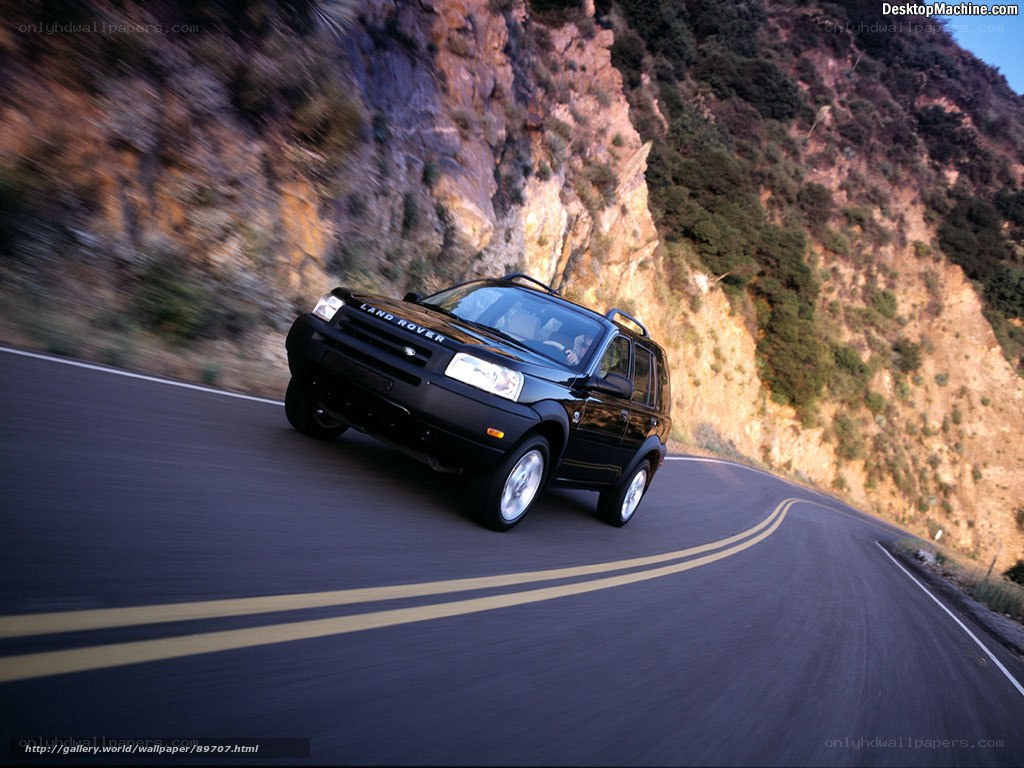 Black Land Rover on winding road