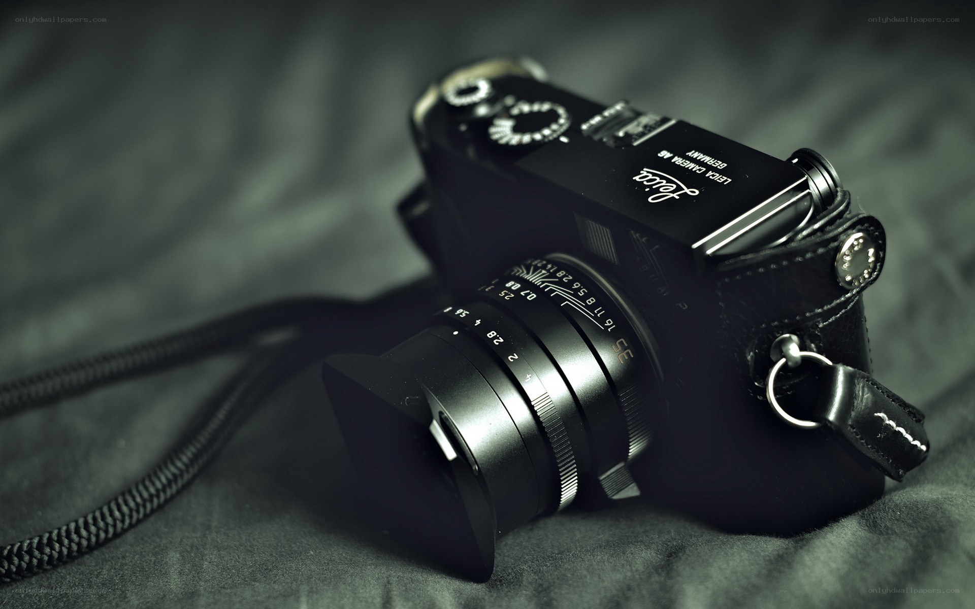 black leica camera on fabric