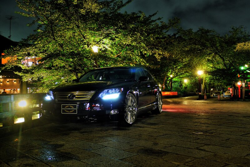 Black Lexus at night on a wet street