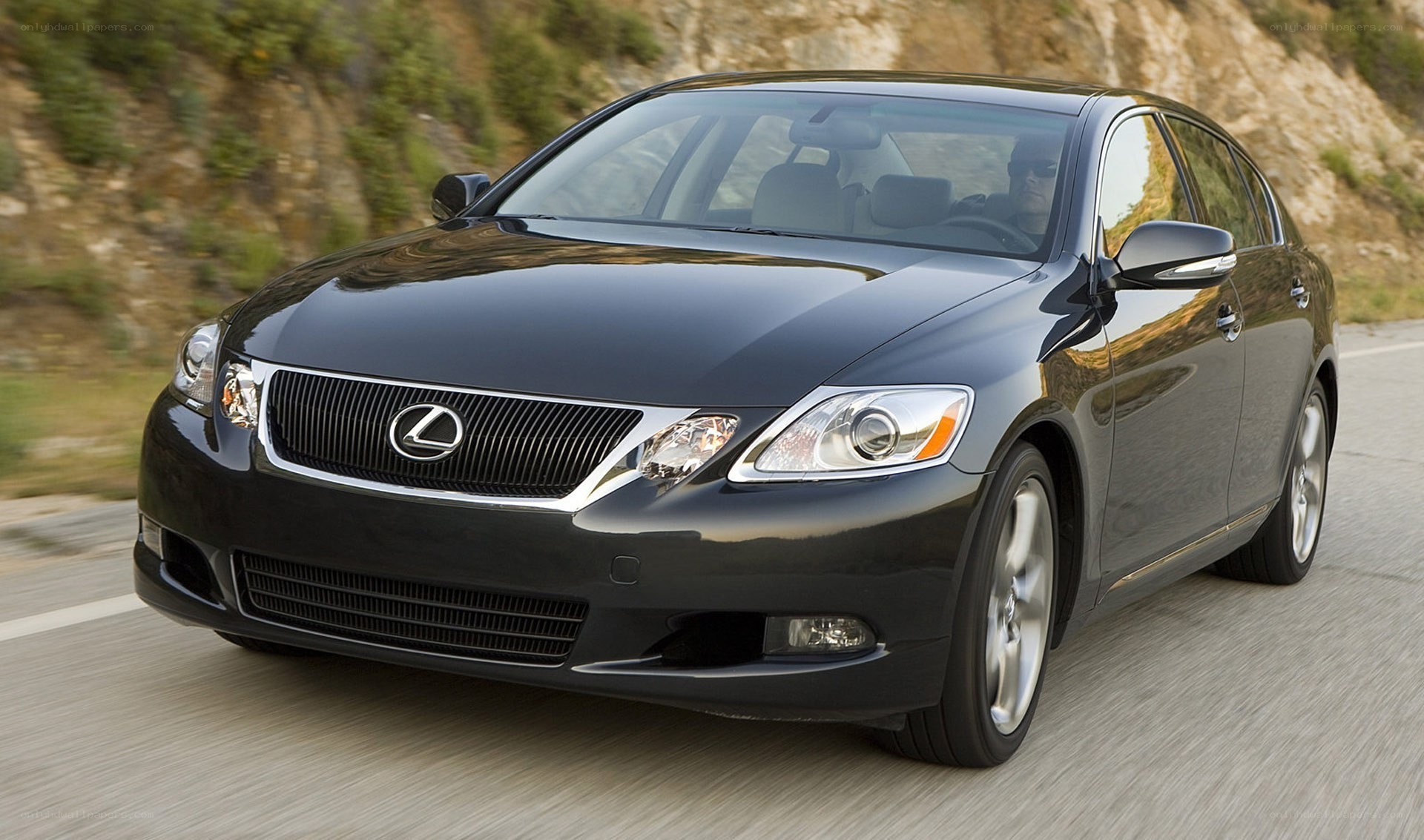 black lexus gs driving on road