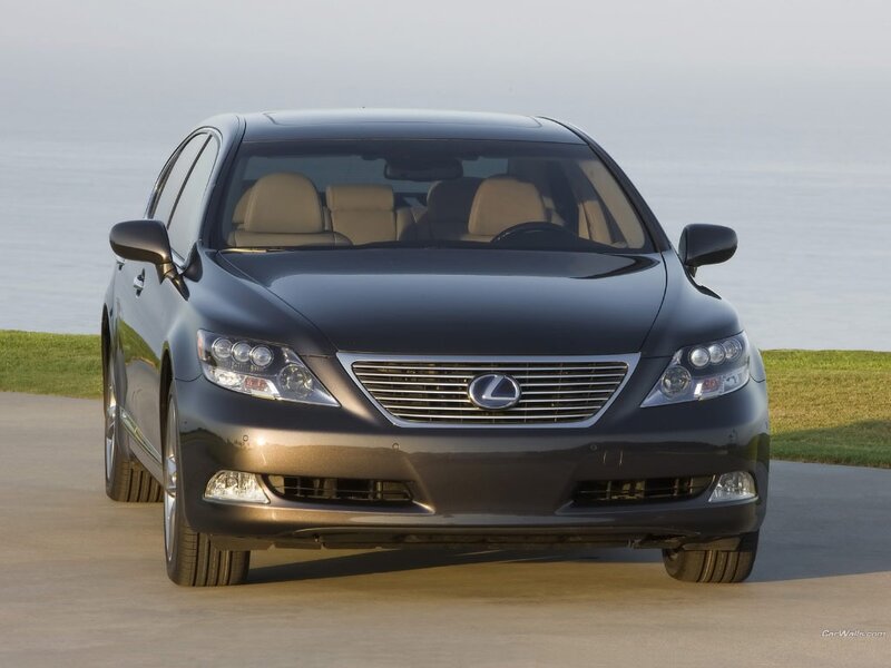 Black Lexus LS sedan on a coastal road