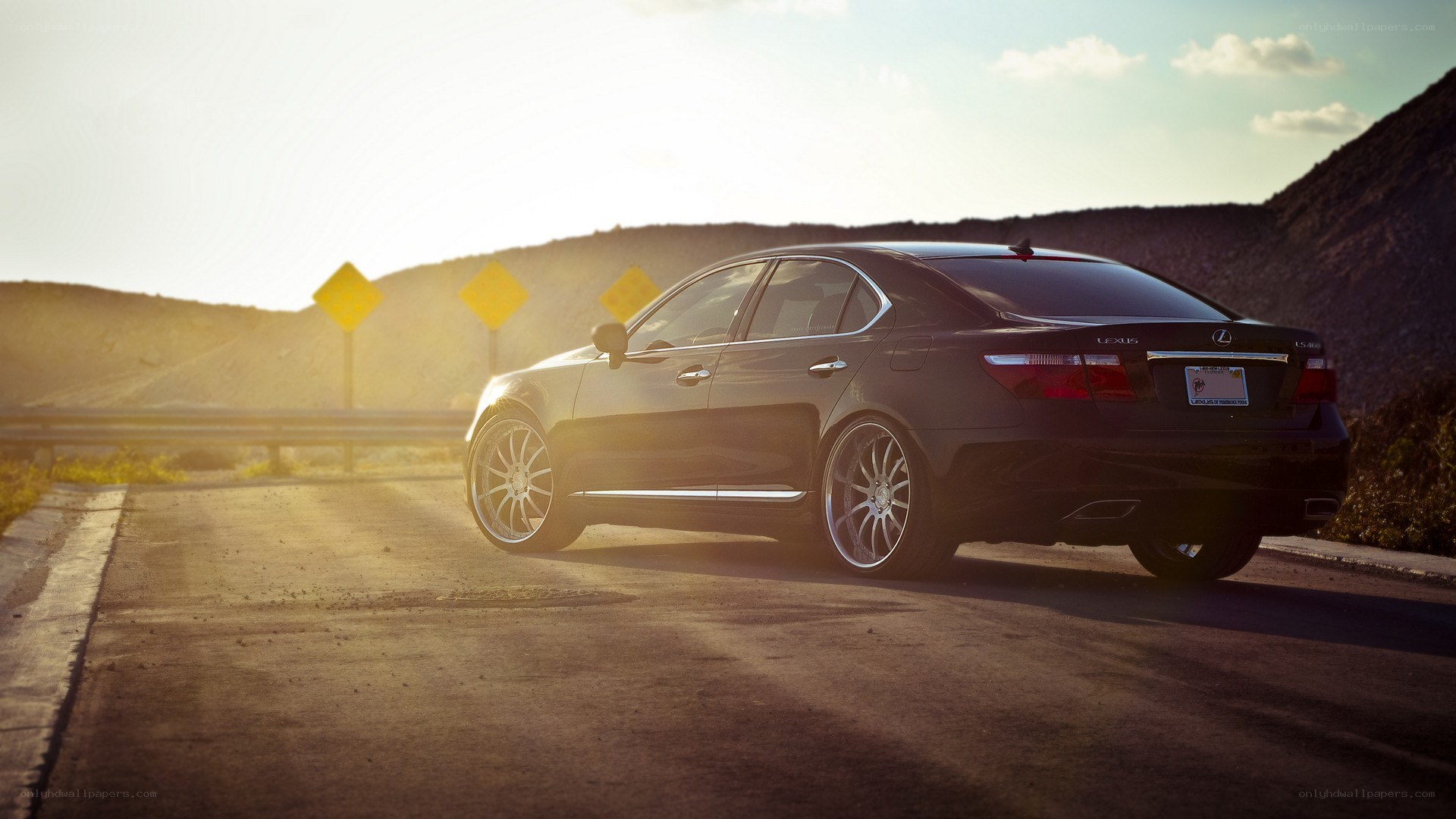 Black Lexus on a desert road