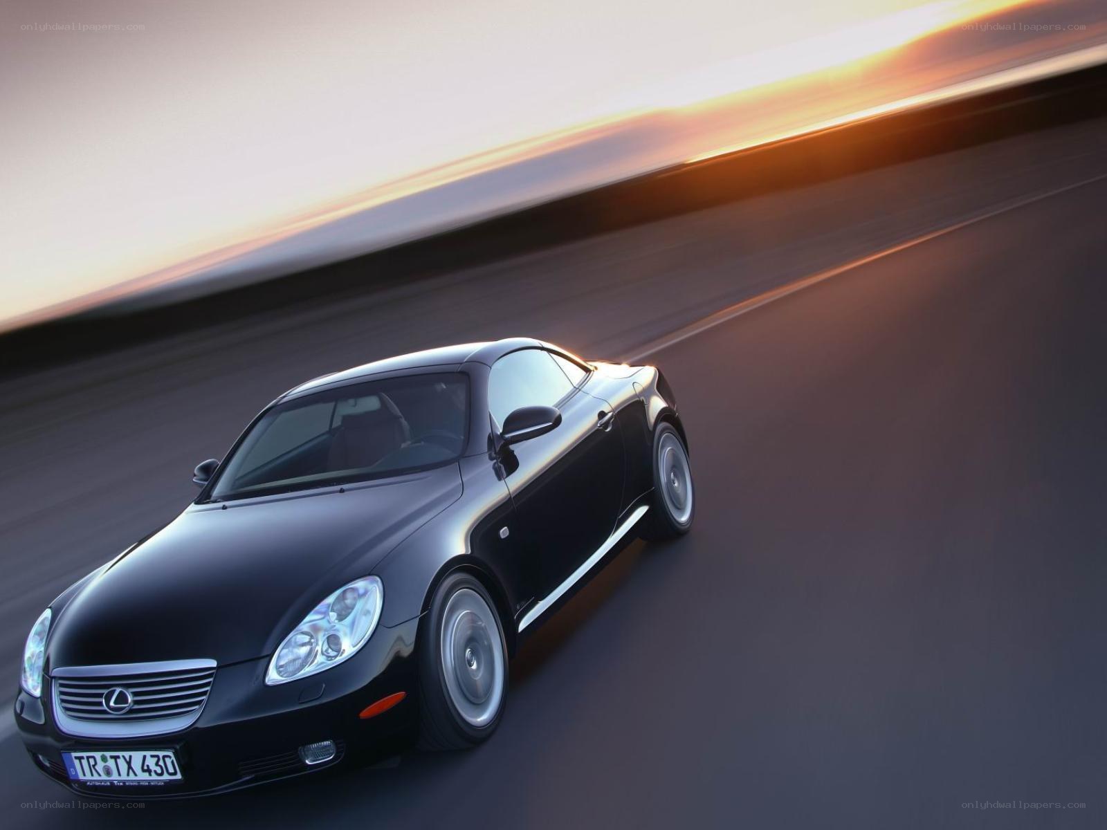 Black Lexus SC driving at sunset