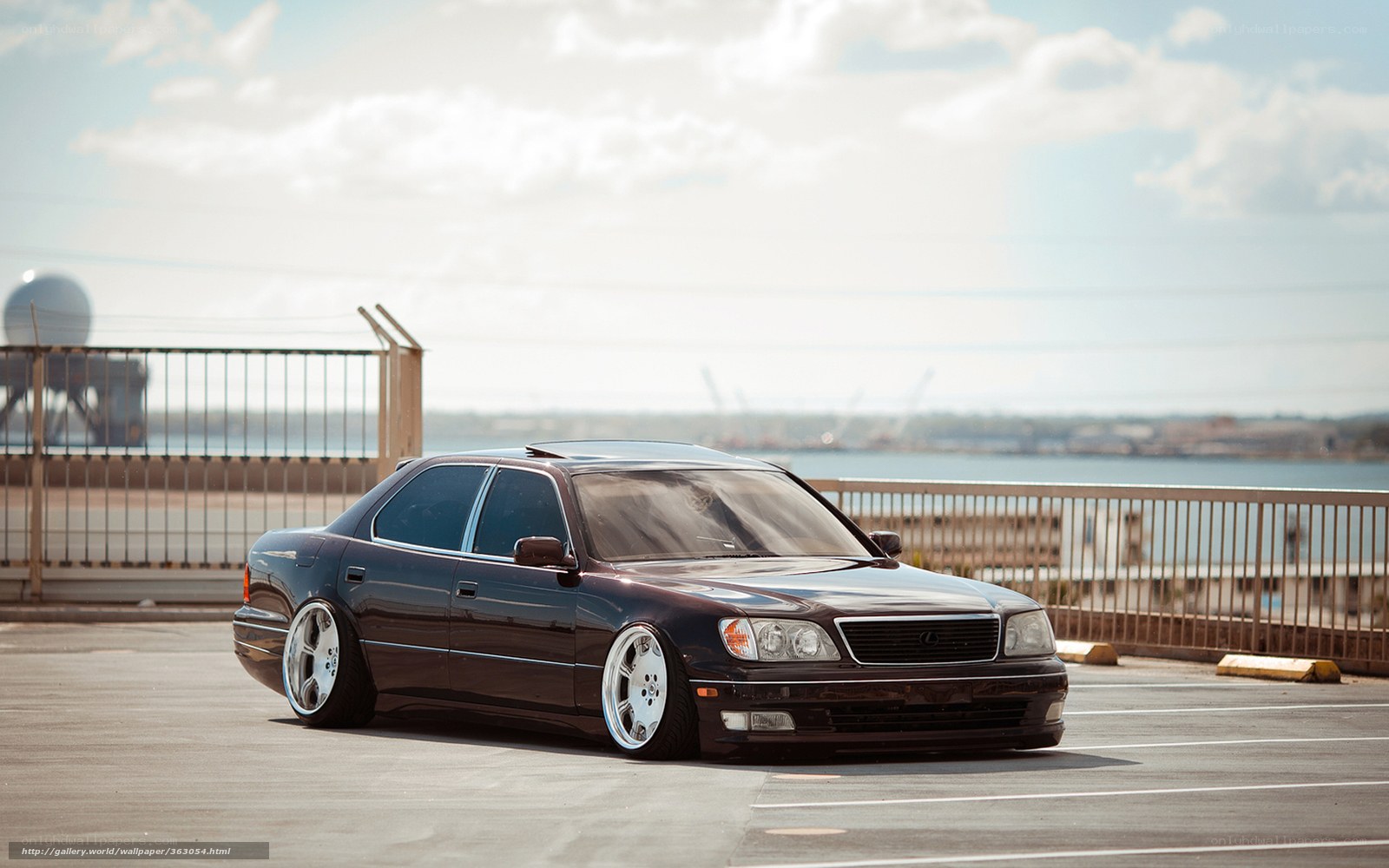 Black Lexus sedan on a pier