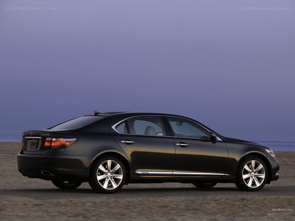 black lexus sedan on beach