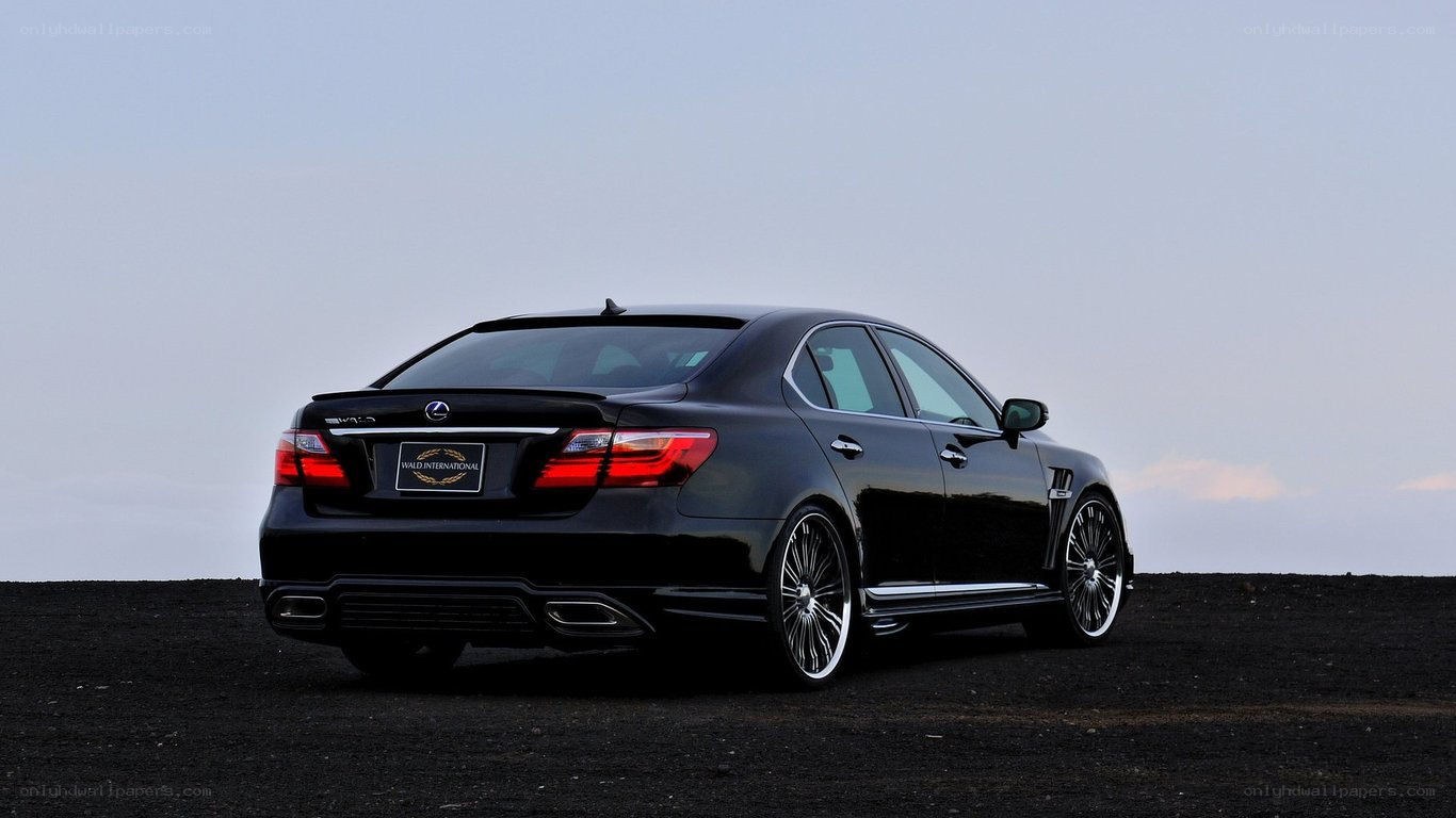 black lexus sedan on black sand
