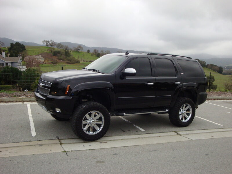 black lifted suv in parking lot