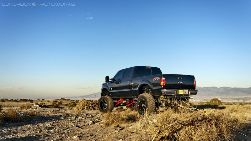Black lifted truck in desert