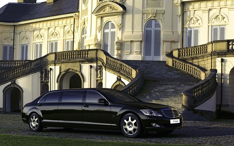 Black limousine in front of a palace
