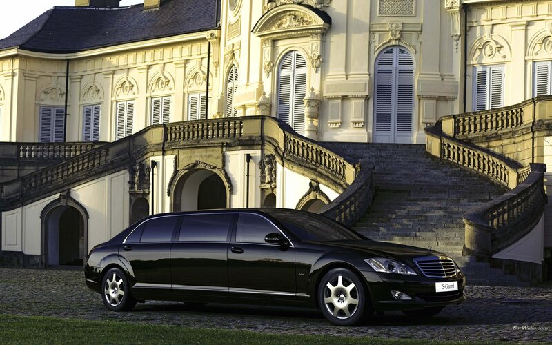 Black limousine in front of palace