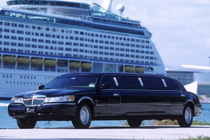Black limousine near cruise ship