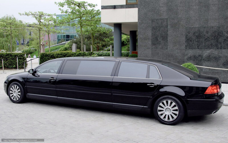Black limousine parked outside building