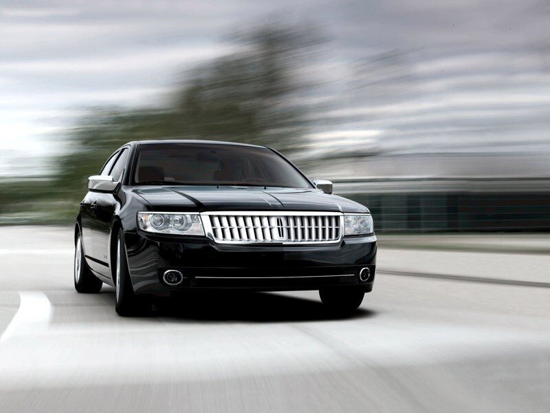 black lincoln sedan in motion
