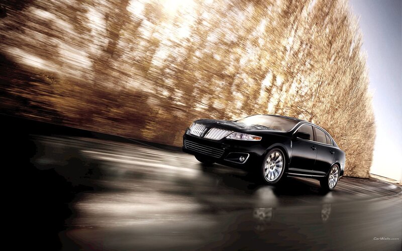 Black Lincoln sedan in motion