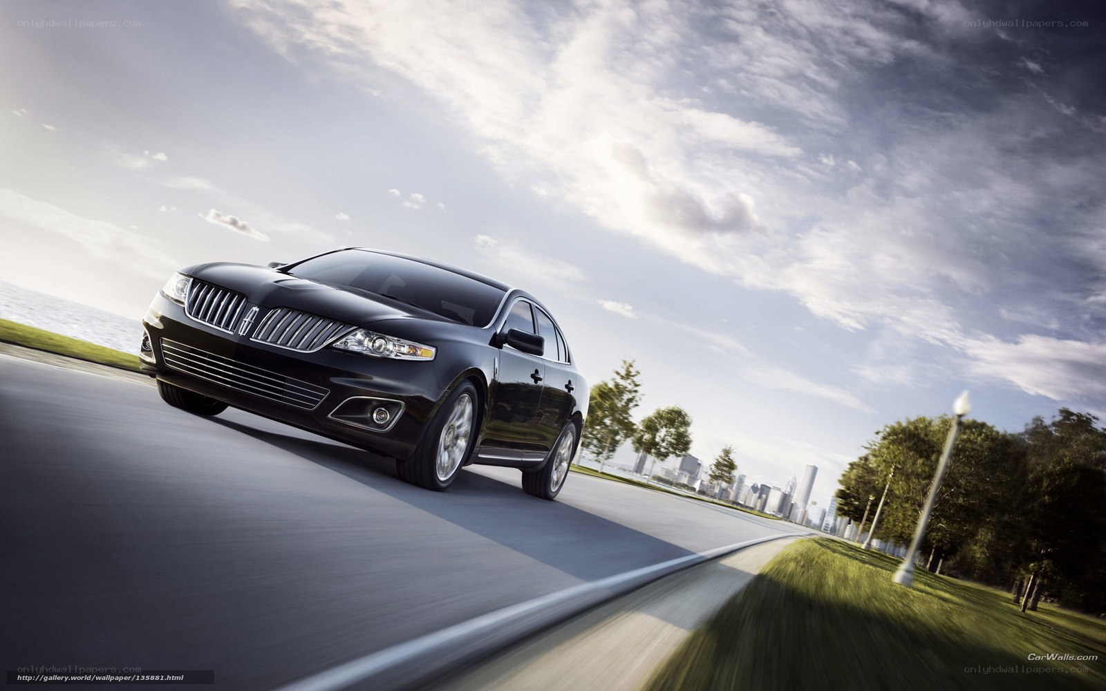 Black Lincoln sedan on a coastal road