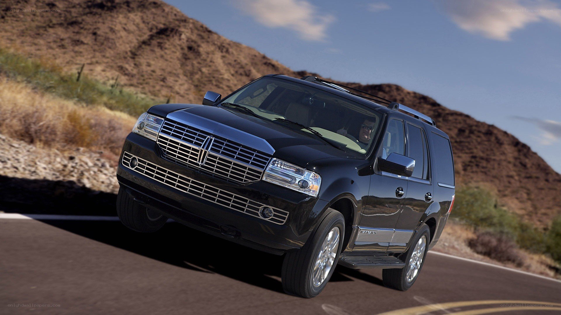 Black Lincoln SUV on desert road