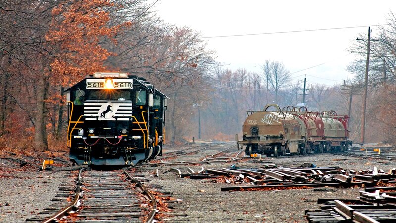 Black Locomotive on Tracks — Brown