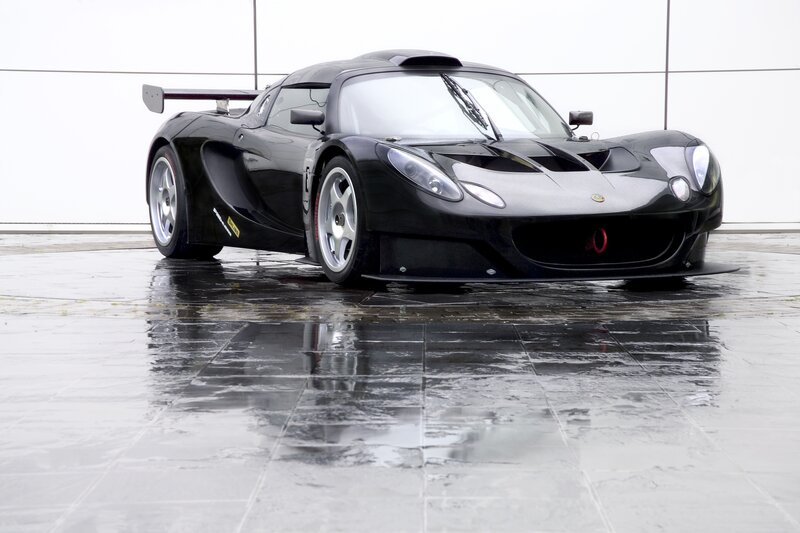 Black Lotus race car on wet pavement