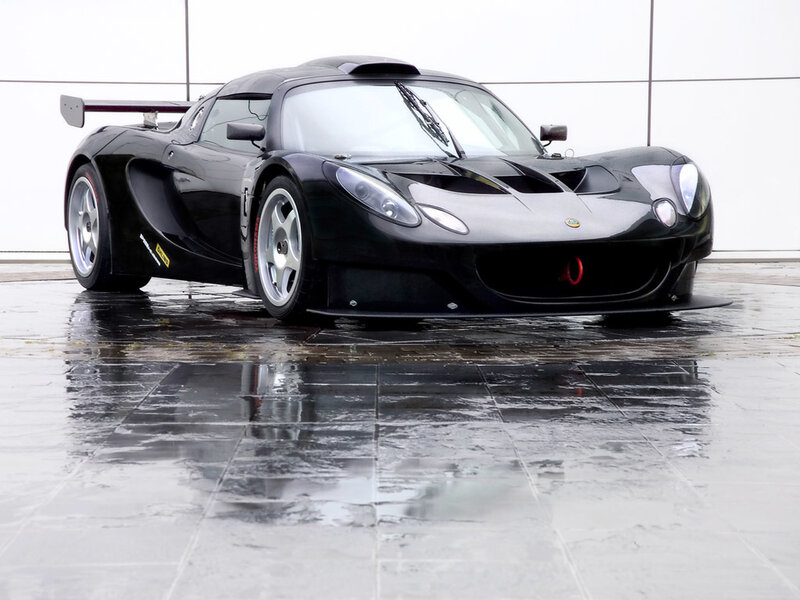 Black Lotus race car on wet pavement