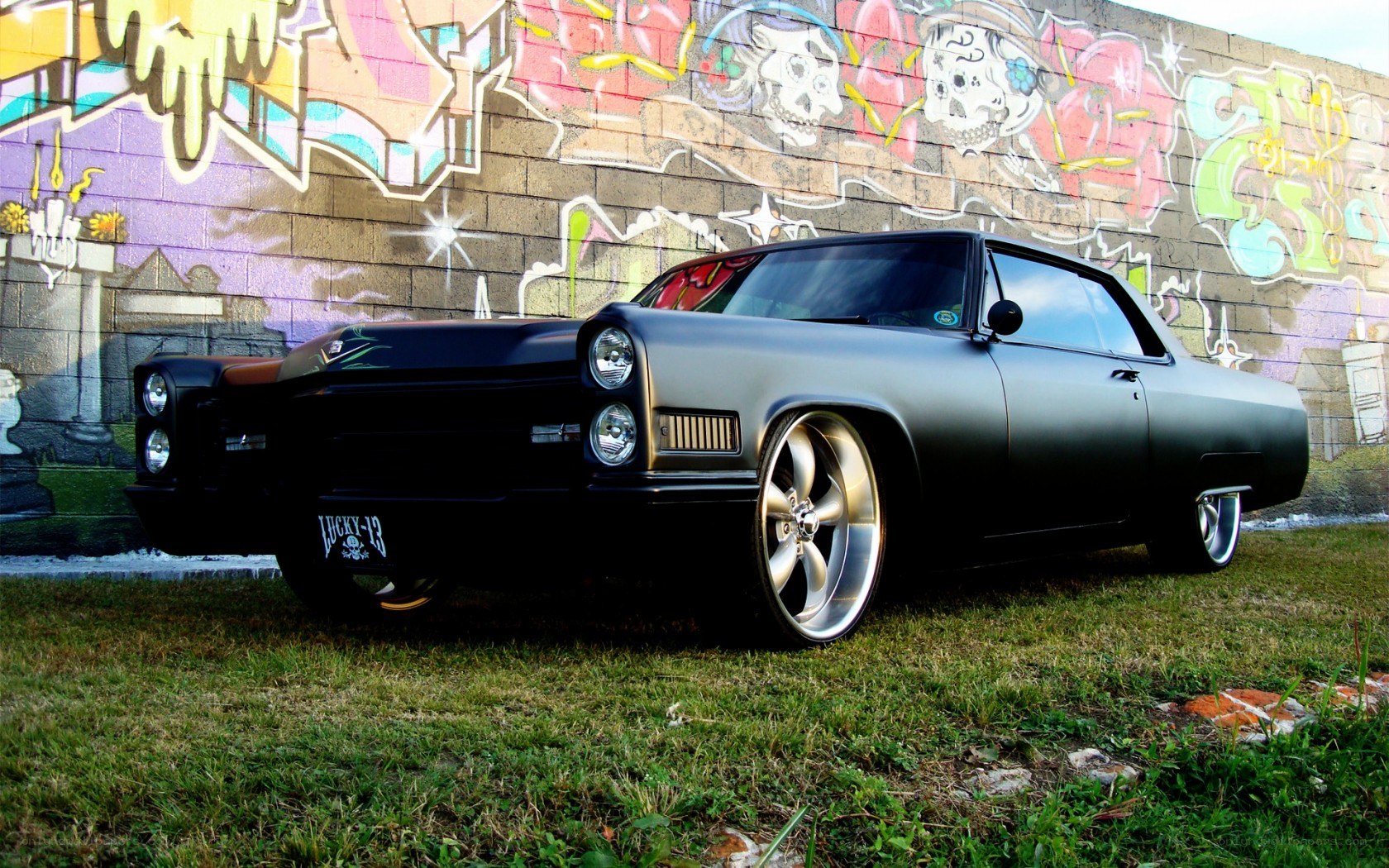 Black lowrider car with graffiti